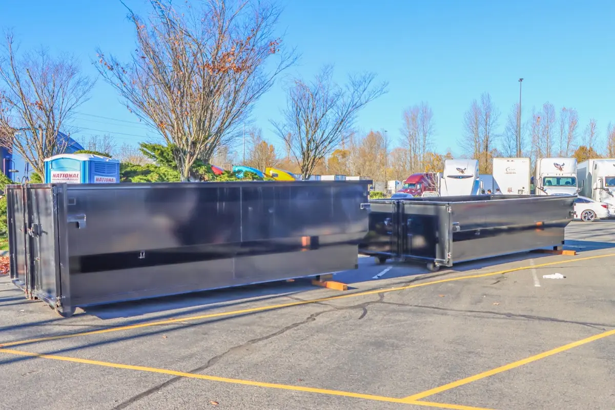 Professional dumpster rental service with roll-off container on residential driveway in Chevy Chase